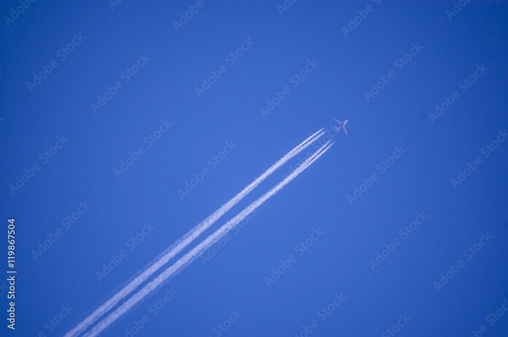 Plane flying on a perfectly blue sky with vapor trail Plane flying on a perfectly blue sky with vapor trail