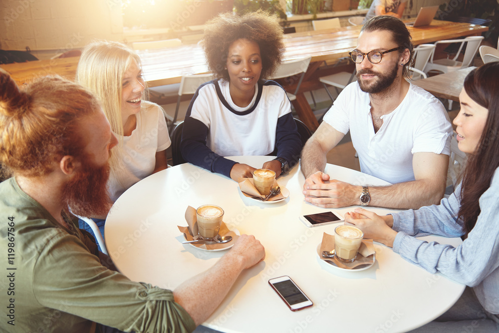 Togetherness and community. Startup team sitting at round table at cafe