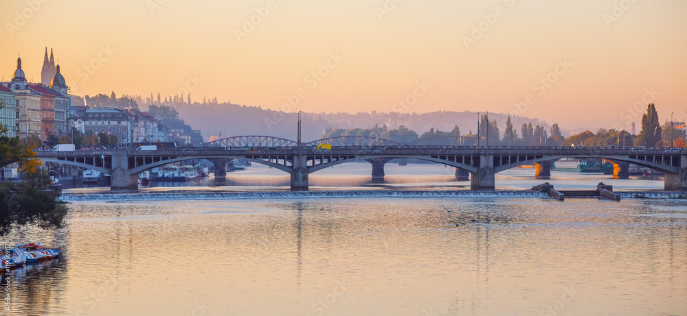 Sunrise early morning over bridge on Vltava river in Prague