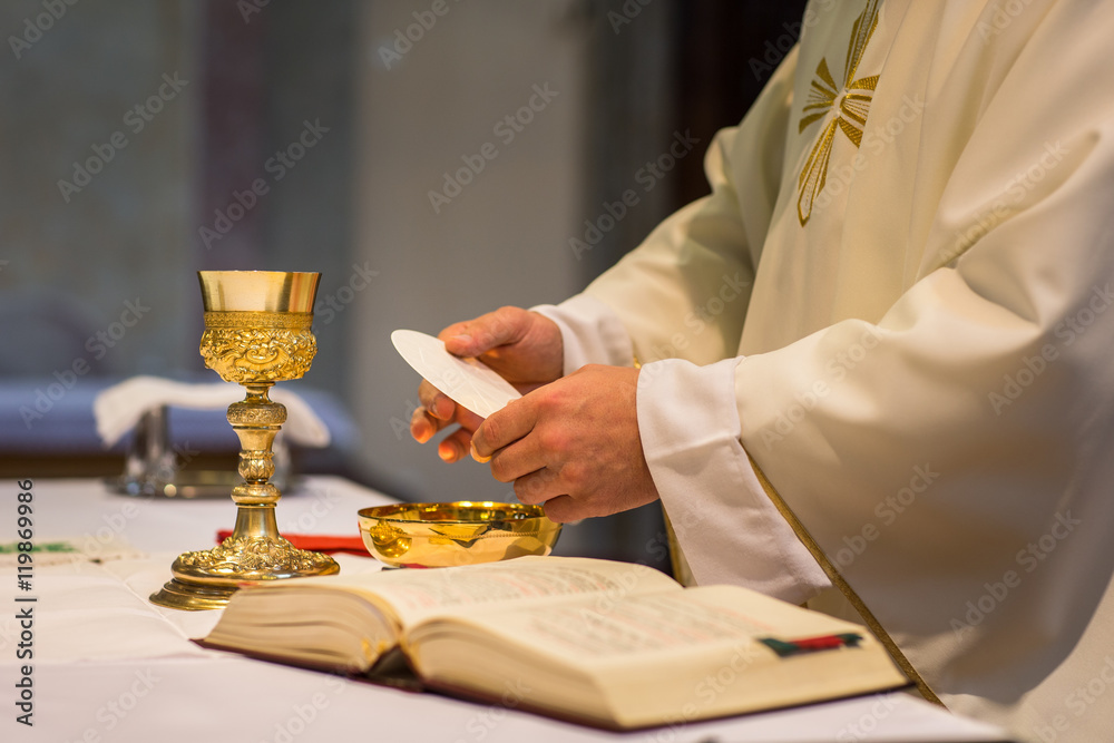 Priest during a wedding ceremony/nuptial mass  - obrazy, fototapety, plakaty 