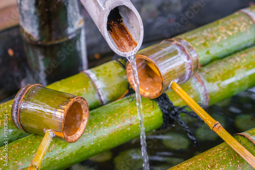 Water running out through bamboo pipe . photo