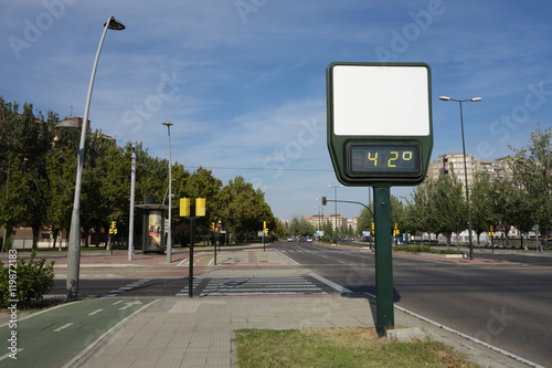 high temperature on a wide street. A thermometer with no advertisement showing 42 degrees