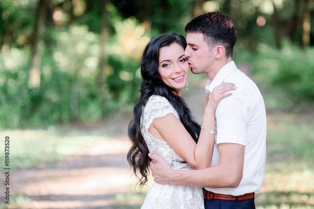 Beautiful luxury newlyweds posing outside