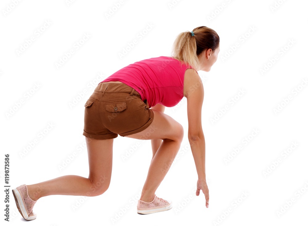 side view woman start position. Isolated over white background. Sport blond in brown shorts in the starting position side view woman start position. Isolated over white background. Sport blond in brown shorts in the starting position