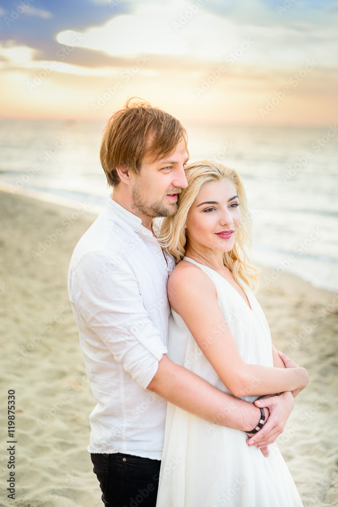 Beautiful stylish couple posing on the beach