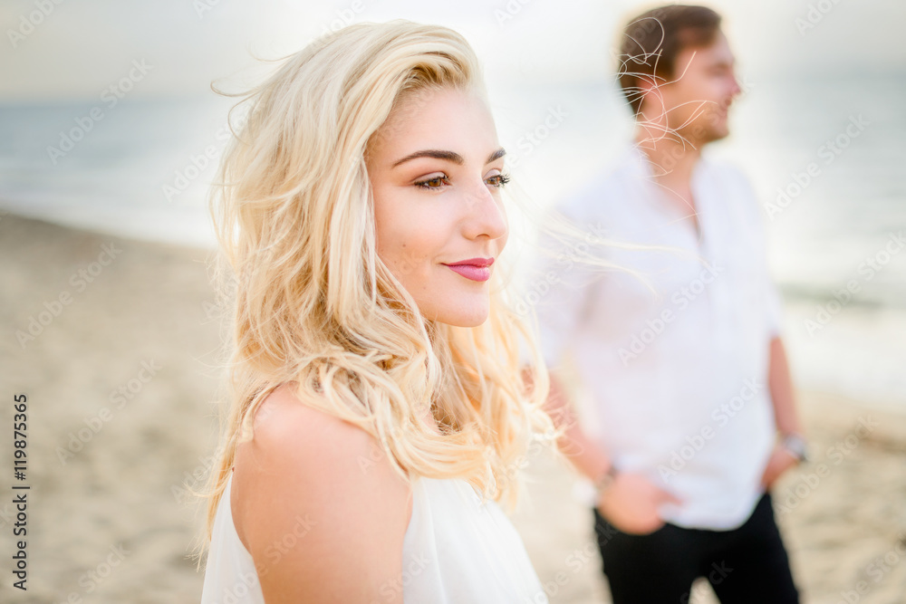Beautiful stylish couple posing on the beach Beautiful stylish couple posing on the beach