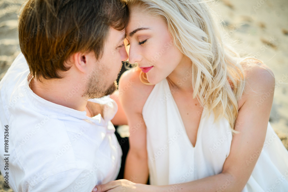 Beautiful stylish couple posing on the beach Beautiful stylish couple posing on the beach