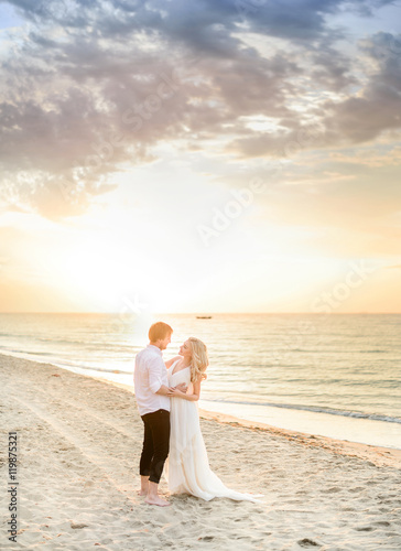Beautiful stylish couple posing on the beach
