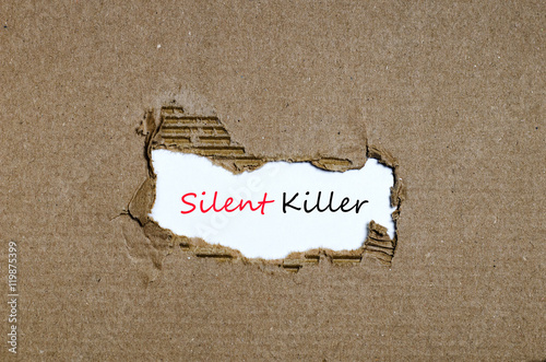 Tablou pe pânză The word silent killer appearing behind torn paper