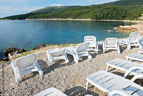 Pebble beach with chaise-longues in Istria