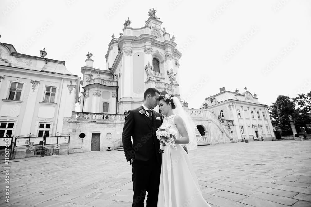 Amazing wedding couple near old monumental church