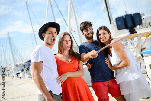 group of four young people making selfie on the harbor of touristic resort © W PRODUCTION