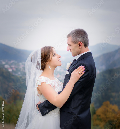 Beautiful luxury newlyweds posing outside © IVASHstudio