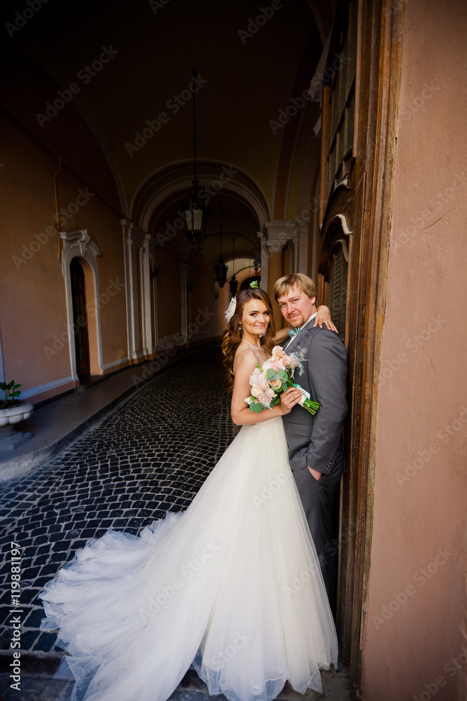 Cute bride in amazing white dress with her handsome groom