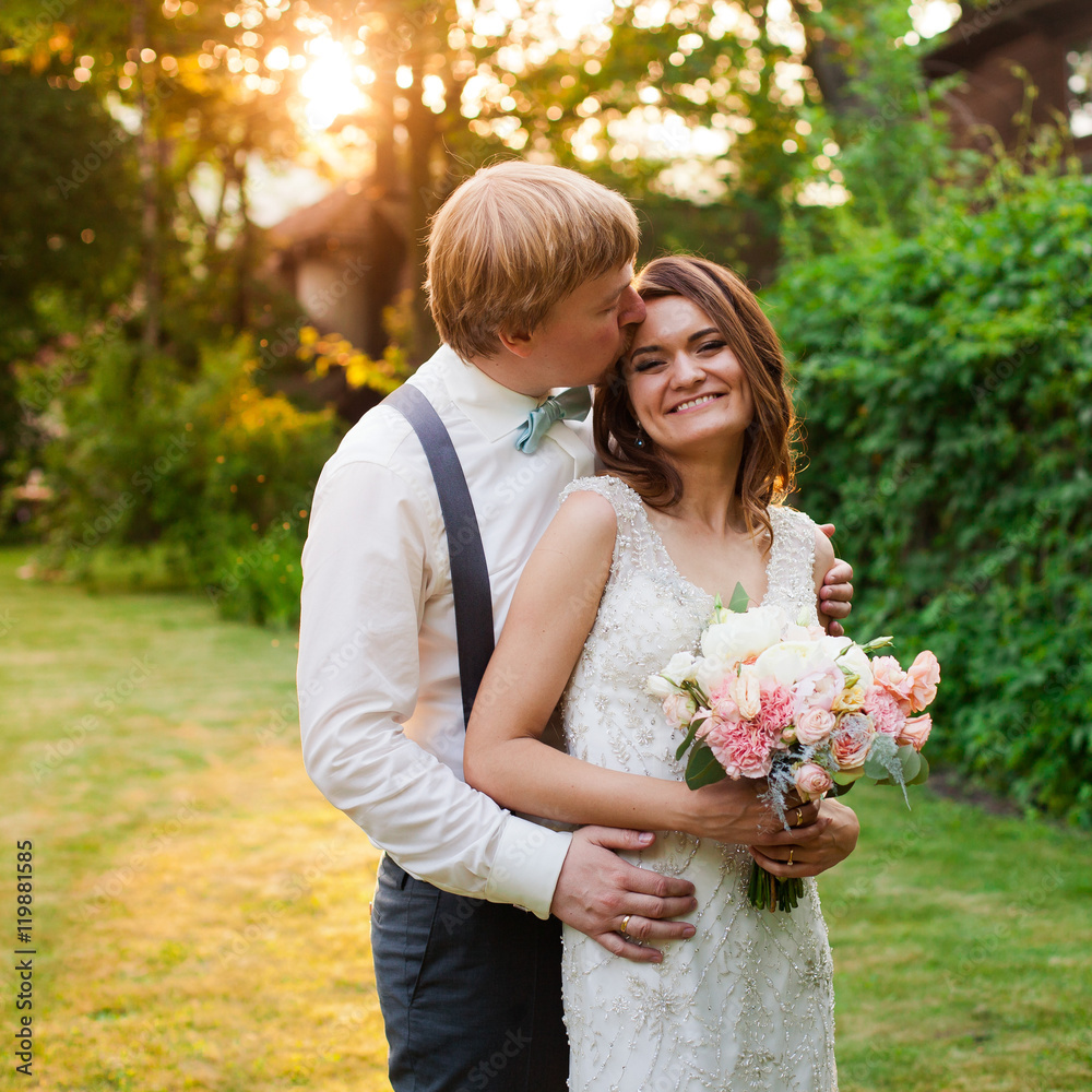 Happy bride with her tender bouquet and handsome groom Happy bride with her tender bouquet and handsome groom