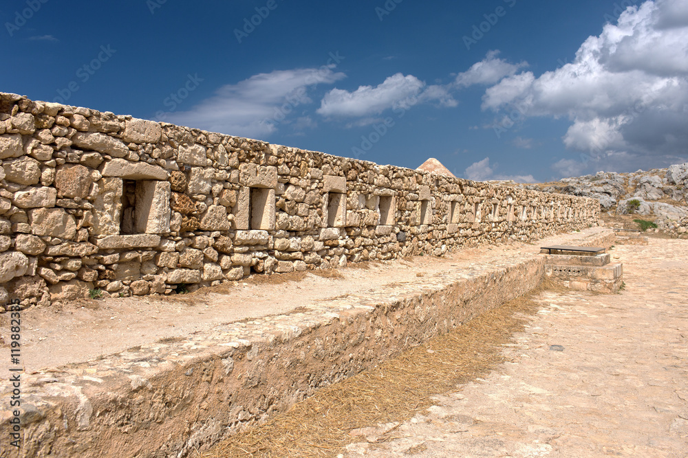 The wall of the old fortress with loopholes