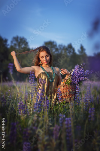 Beautiful girl in  lupine field.