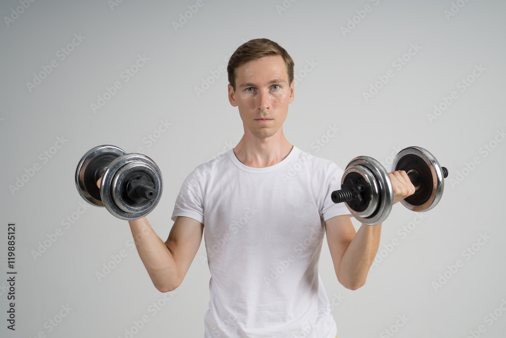 Young Man doing Exercise with Dumbbells.