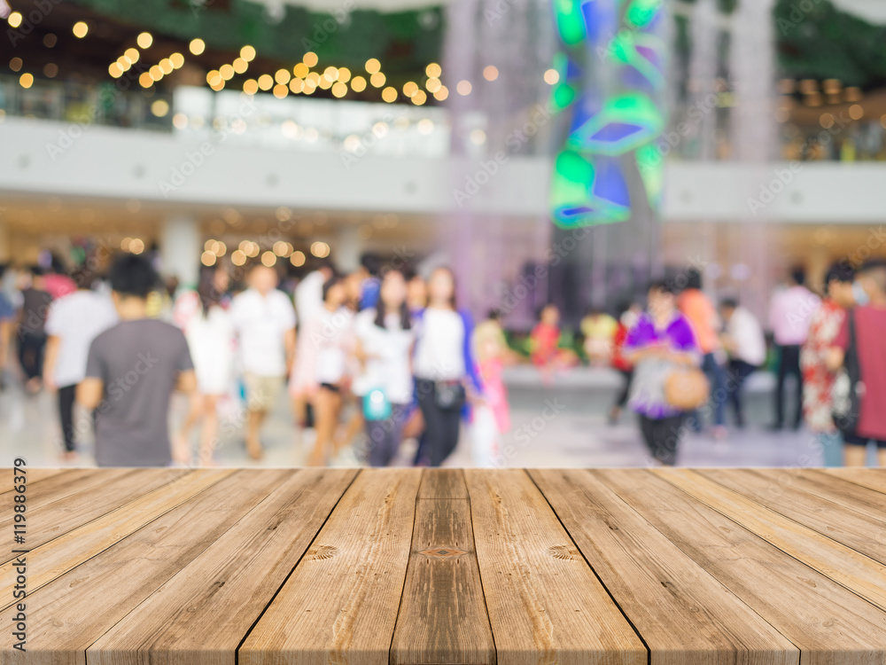 Wooden board empty table in front of blurred background. Perspective brown wood over blur people in shopping mall - can be used for display or mock up montage your products.
