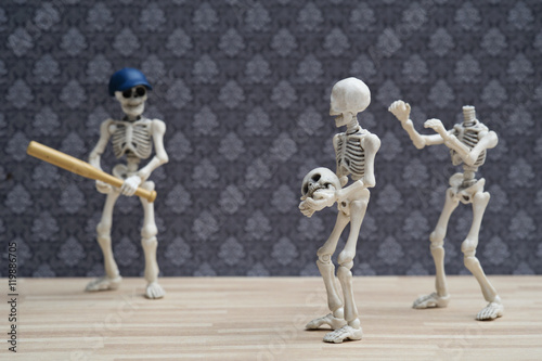 Two skeletons use their friend's head playing baseball