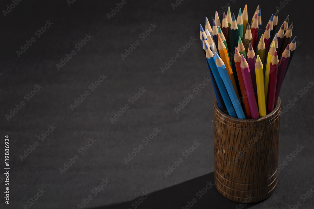Bunch of color pencils in a dark room