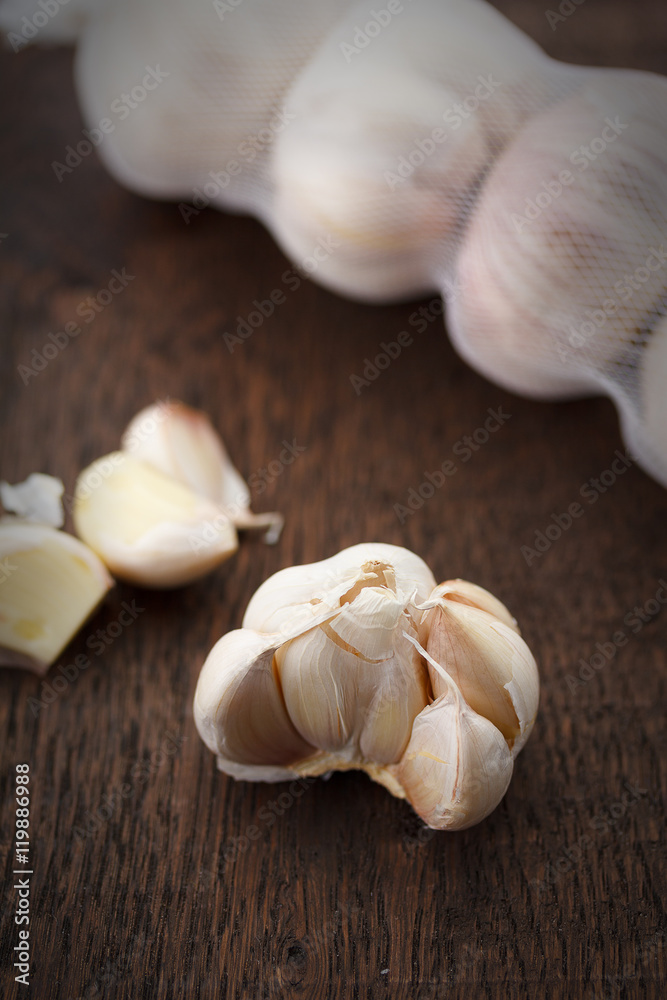 garlic bulbs with garlic cloves on a wooden table garlic bulbs with garlic cloves on a wooden table