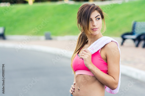 Athletic woman with towel after training