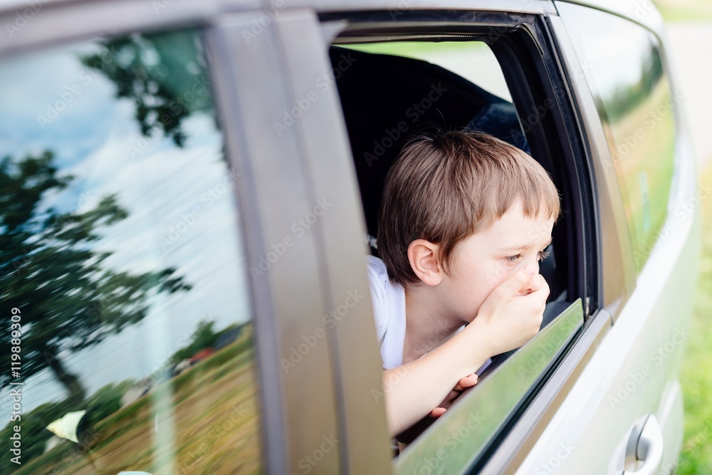 Child suffers from motion sickness in car - obrazy, fototapety, plakaty 