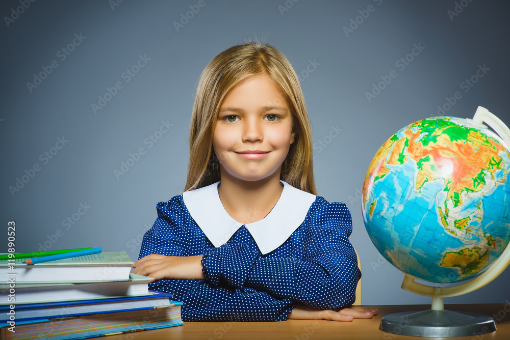 school concept. girl sitting at the desk in the classroom Geography school concept. girl sitting at the desk in the classroom Geography