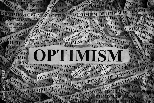 Photos Torn pieces of paper with the word Optimism