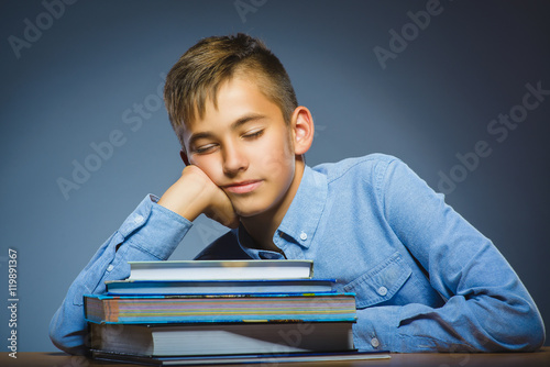 school concept. Closeup portrait boy asleep on pile of books