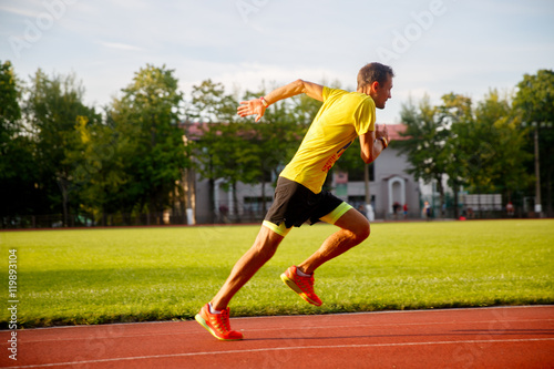 young runner runs stadium summer