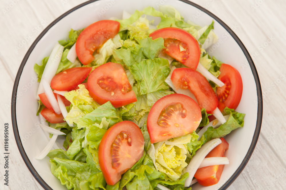 Salad bowl on a white wooden background Salad bowl on a white wooden background