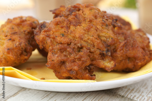 Onion Bhajis a spicy Indian snack of onions fried in batter photo