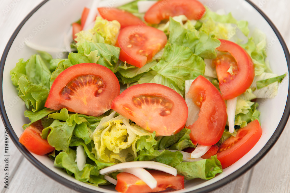 Salad bowl on a white wooden background