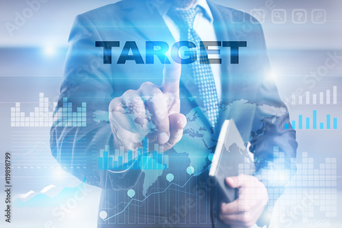 Businessman is pressing button on touch screen interface and selecting "Target".