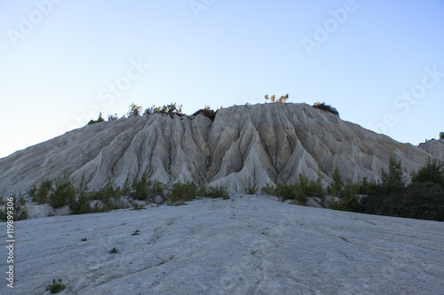 Limestone hill in the abandoned quarry, Rummu, Estonia photo