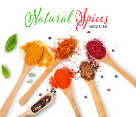 Fototapete Gewürze Composition of different spices in wooden spoons isolated on white  © Africa Studio