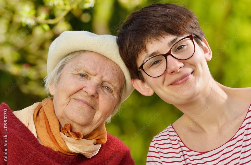 Grandmother and granddaughter. Young woman carefully takes care