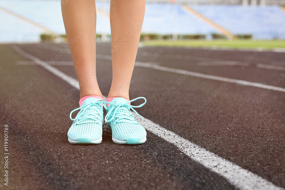 Woman wearing mint sneakers on a running stadium Woman wearing mint sneakers on a running stadium
