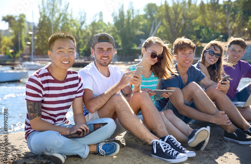 Young people with gadgets h...
