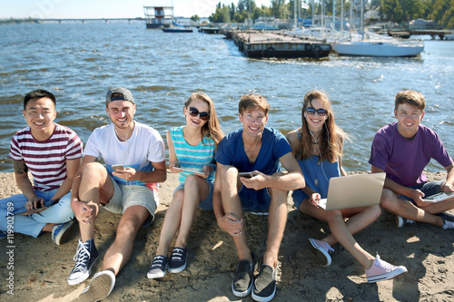 Young people with gadgets h...