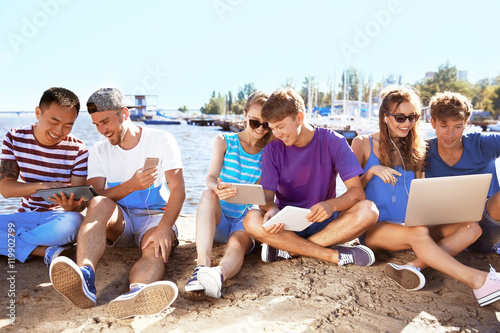 Young people with gadgets h...