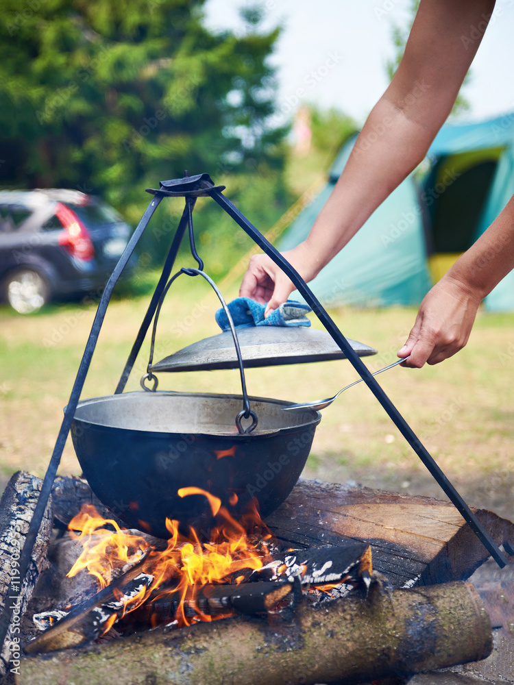 Cooking food over campfire in hike Cooking food over campfire in hike