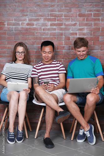 Young people with gadgets h...