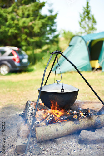 Landscape with capmfire, pot, car and tent