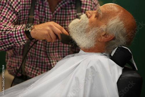 Elderly bearded man at barb...