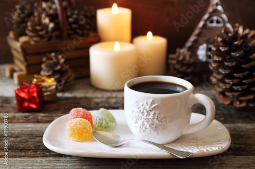 Cup of coffee  pine cones  burning candles and colorful candy