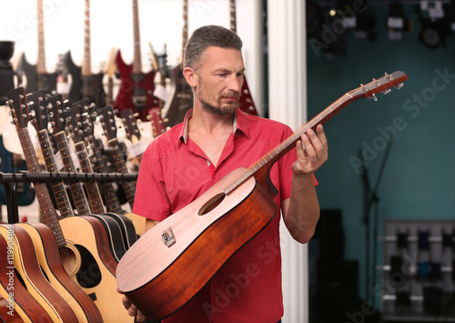 Man playing guitar in music shop