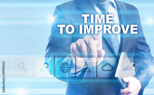 Businessman is pressing button on touch screen interface and selecting "Time to improve".